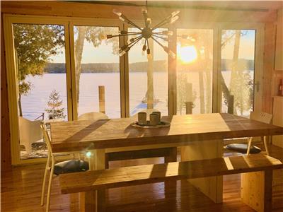 Charming cottage with huge windows with lake view, slow burning fireplace, campfire by the lake